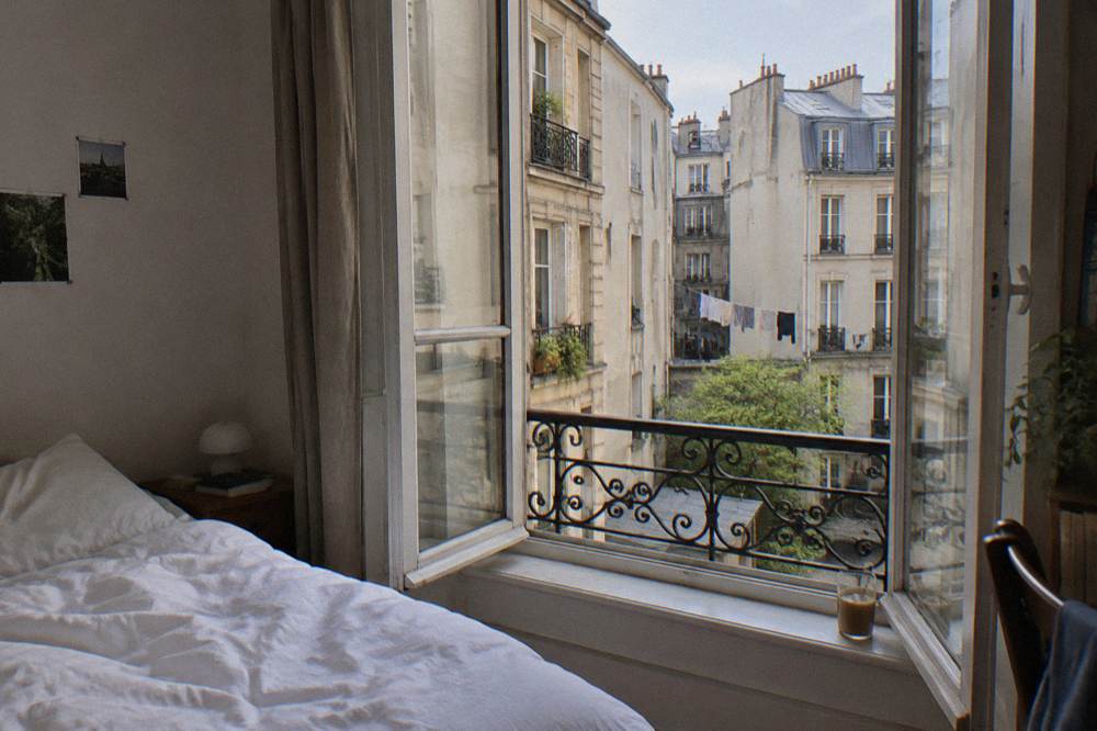 A double room in a Paris hotel with a window open onto a courtyard